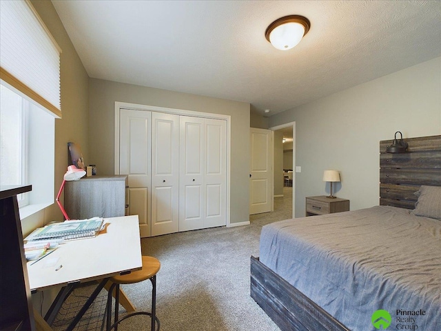 carpeted bedroom featuring a closet and a textured ceiling