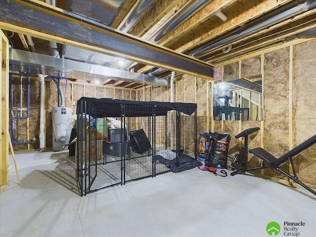 unfinished basement featuring gas water heater