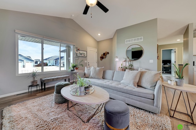 living room with visible vents, wood finished floors, baseboards, lofted ceiling, and ceiling fan