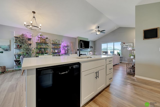 kitchen featuring open floor plan, black dishwasher, light wood-style floors, white cabinetry, and a sink