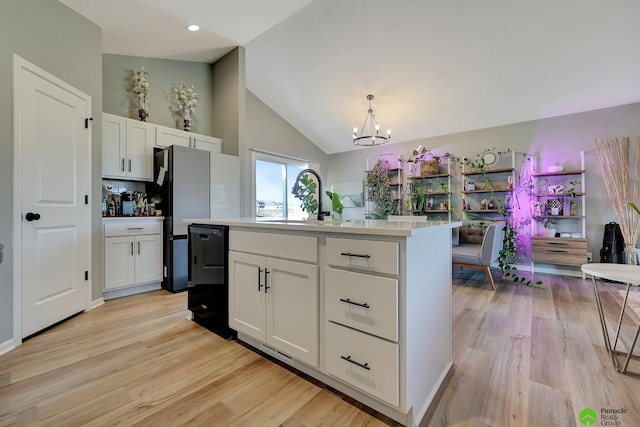 kitchen with dishwasher, light countertops, white cabinets, and a sink