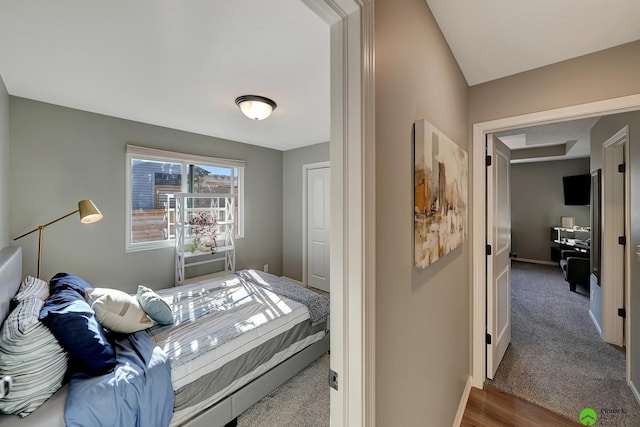 bedroom with carpet flooring and baseboards