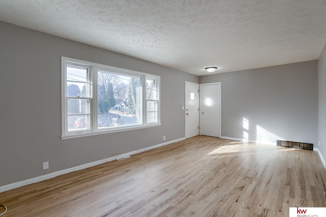 interior space with light hardwood / wood-style floors and a textured ceiling