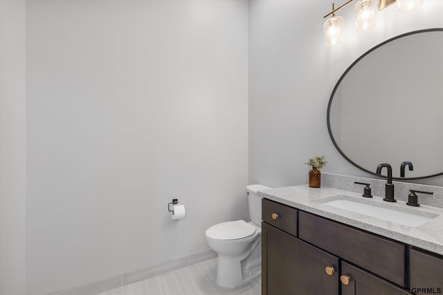 bathroom featuring tile patterned floors, vanity, and toilet