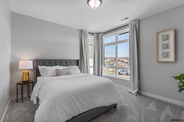 bedroom with carpet and a textured ceiling