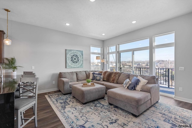 living room featuring a textured ceiling and dark hardwood / wood-style floors