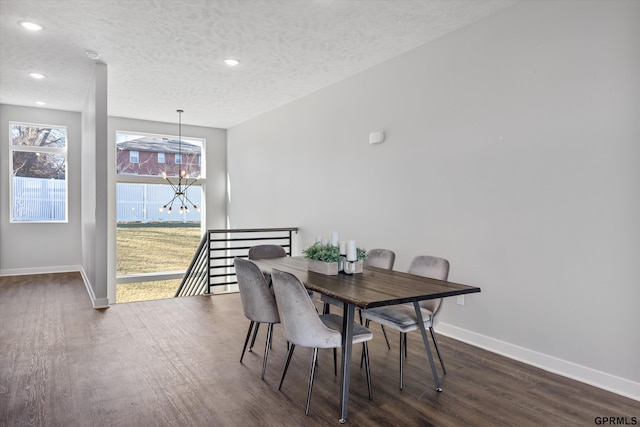 dining space featuring a notable chandelier, recessed lighting, a textured ceiling, wood finished floors, and baseboards