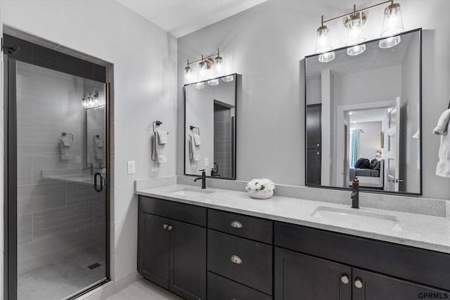 ensuite bathroom featuring a stall shower, double vanity, a sink, and ensuite bathroom