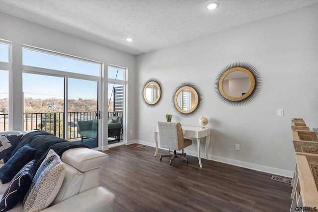 office featuring visible vents, baseboards, dark wood-type flooring, a textured ceiling, and recessed lighting