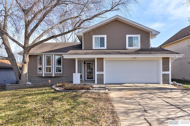 tri-level home featuring a garage and a front lawn