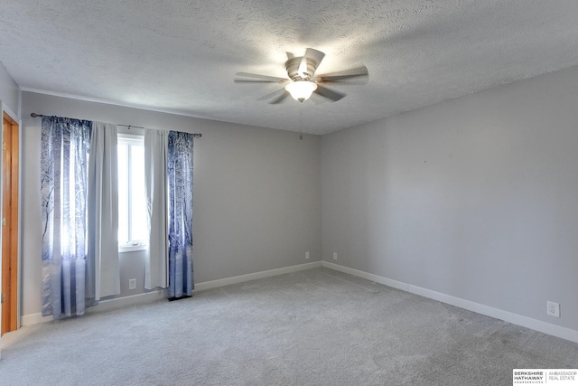 unfurnished room featuring ceiling fan, a textured ceiling, and light carpet