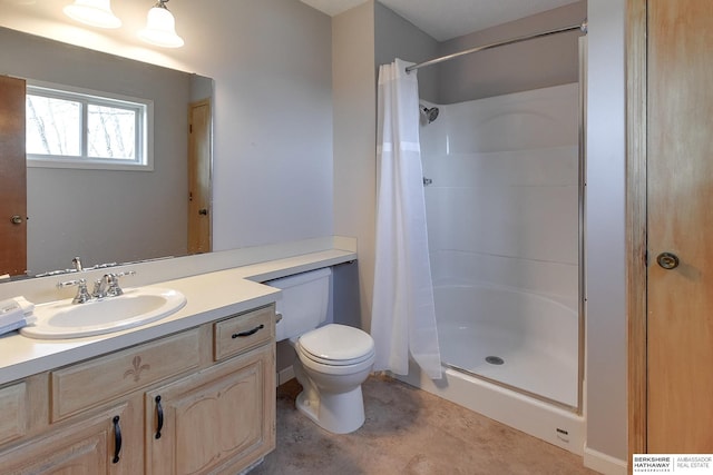 bathroom with vanity, toilet, and walk in shower