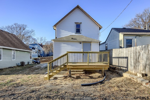 rear view of house featuring a wooden deck