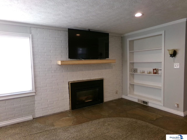 unfurnished living room featuring built in shelves, a fireplace, a textured ceiling, and ornamental molding