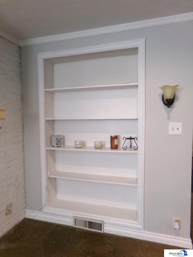 room details with ornamental molding and a textured ceiling