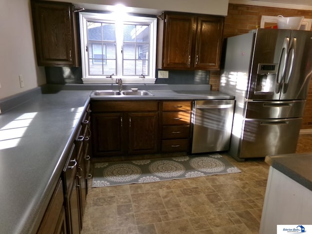 kitchen with decorative backsplash, dark brown cabinetry, sink, and appliances with stainless steel finishes