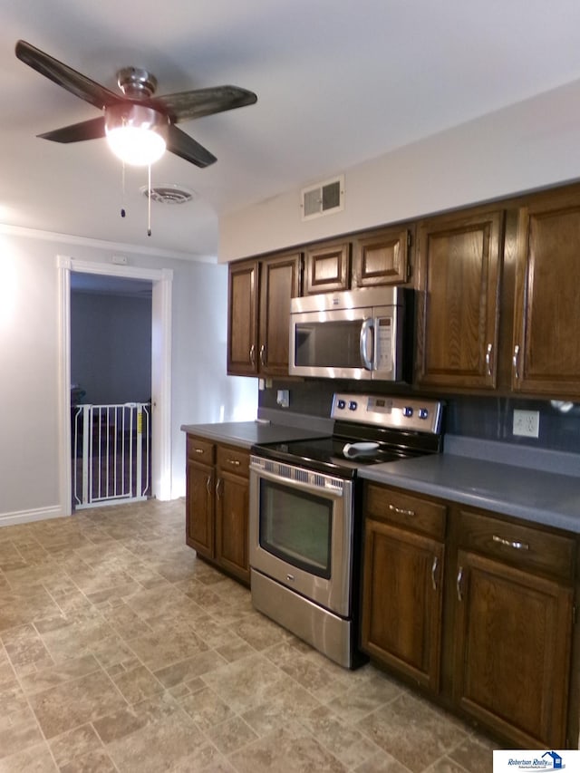 kitchen featuring ceiling fan, dark brown cabinetry, and appliances with stainless steel finishes