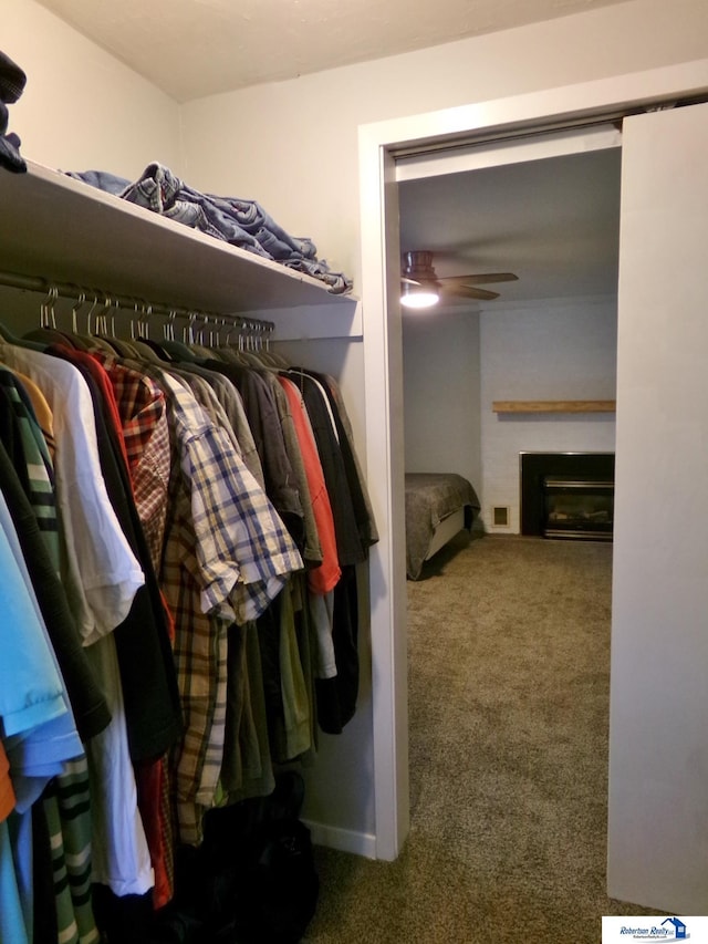 walk in closet with carpet