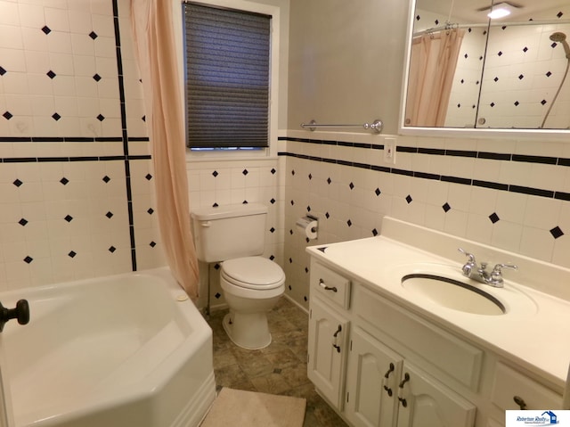 full bathroom with tile patterned flooring, shower / bath combination with curtain, toilet, vanity, and tile walls