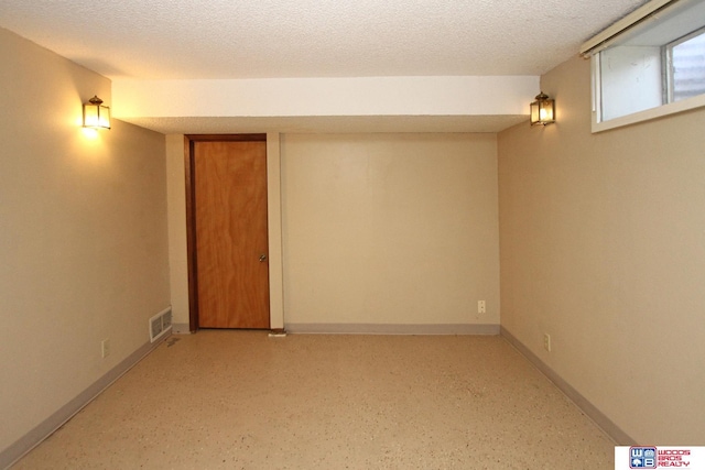 basement featuring a textured ceiling