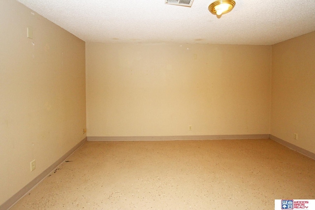 unfurnished room featuring a textured ceiling