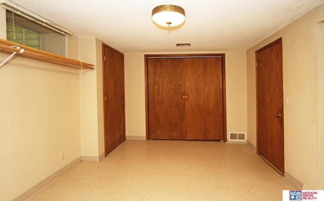 hallway with a textured ceiling