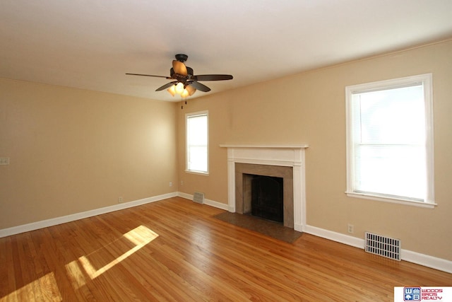 unfurnished living room featuring ceiling fan and light hardwood / wood-style floors