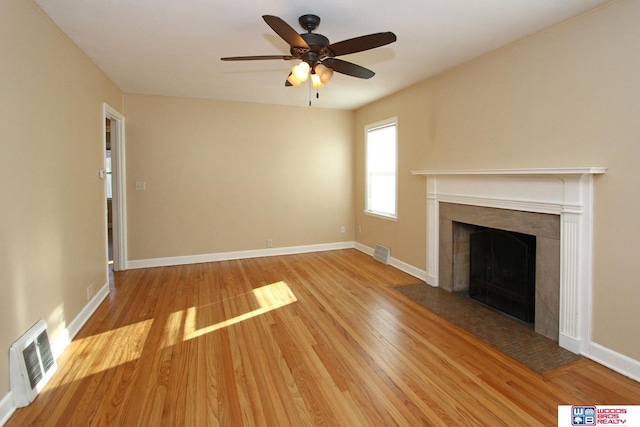 unfurnished living room featuring ceiling fan and light wood-type flooring