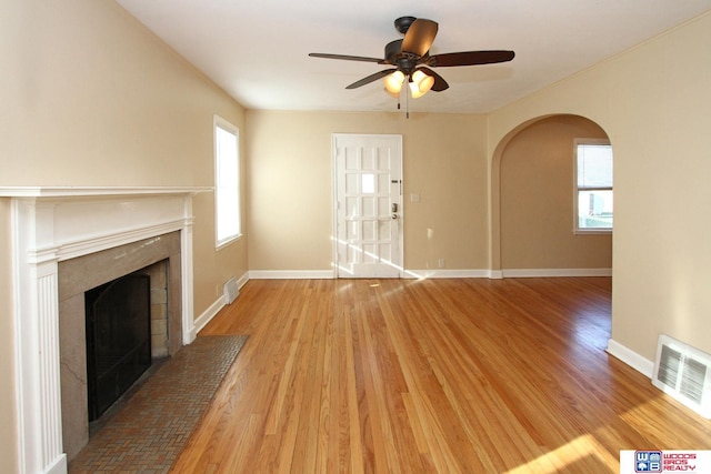 unfurnished living room with ceiling fan and hardwood / wood-style flooring