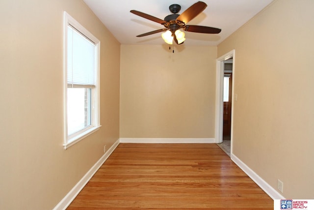 spare room with ceiling fan and light wood-type flooring