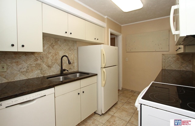 kitchen with white cabinets, white appliances, sink, and tasteful backsplash