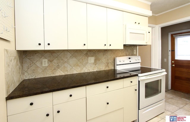 kitchen featuring white cabinets, light tile patterned floors, white appliances, and backsplash