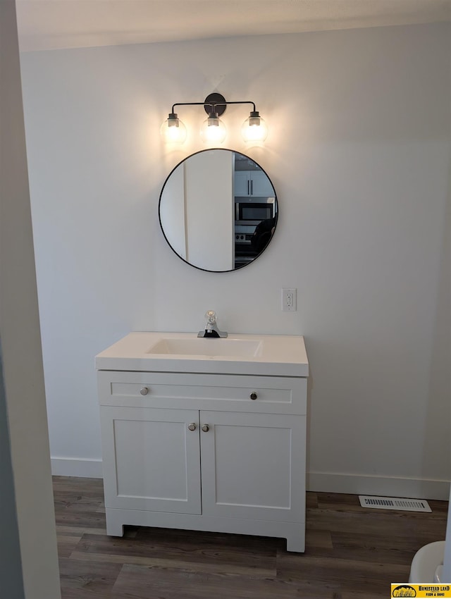 bathroom featuring wood-type flooring and vanity