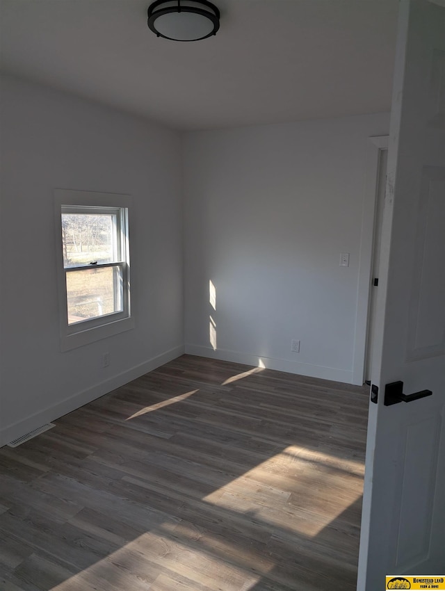 spare room with dark hardwood / wood-style floors