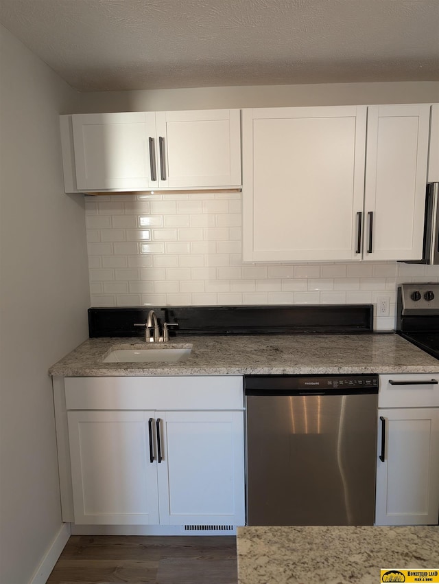 kitchen with dishwasher, white cabinets, range with electric stovetop, and sink