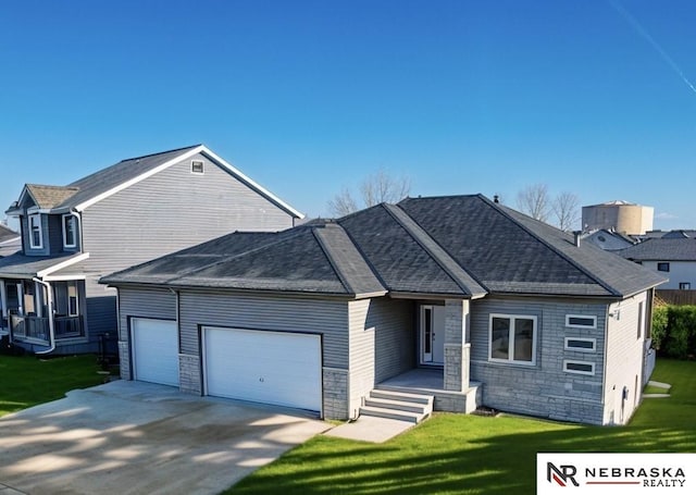 view of front of house with a garage and a front yard