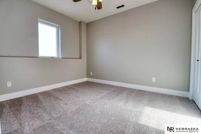 carpeted spare room with ceiling fan