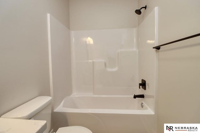 bathroom with shower / bathtub combination and toilet