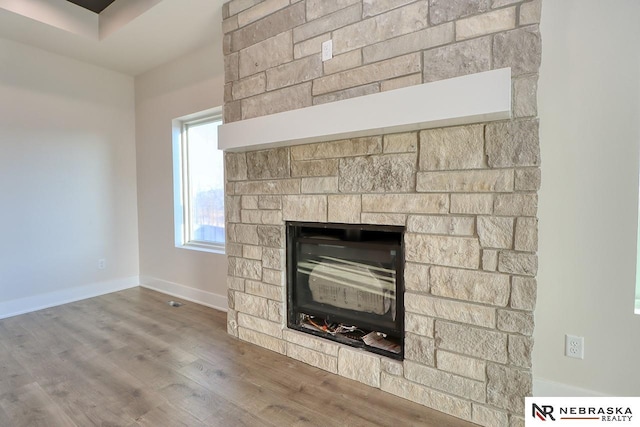 interior details with a fireplace and wood-type flooring