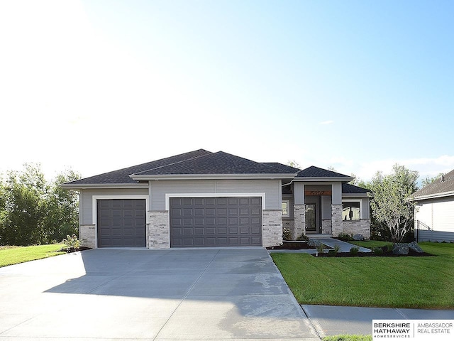 prairie-style house with a front yard and a garage