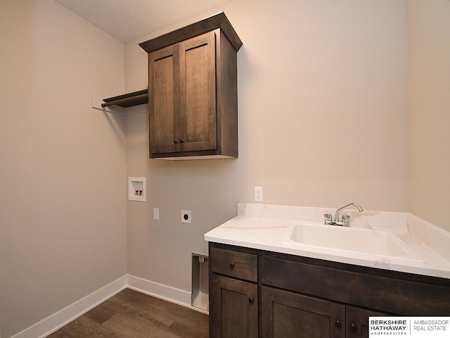 laundry area featuring sink, cabinets, washer hookup, hookup for an electric dryer, and a textured ceiling