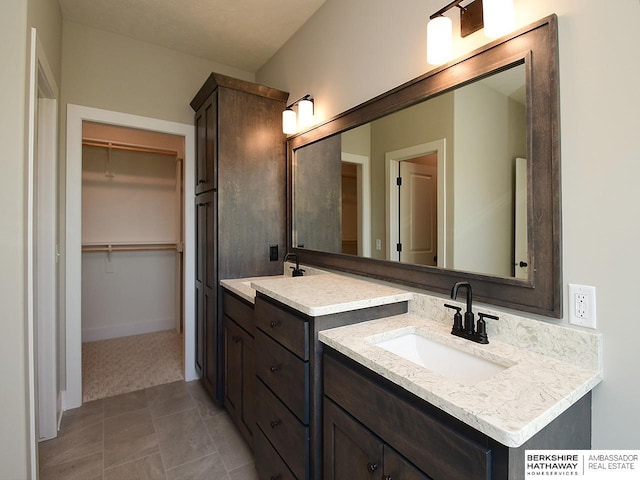 bathroom with tile patterned floors and vanity