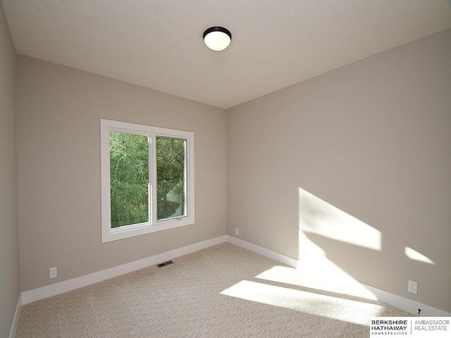 spare room with light colored carpet