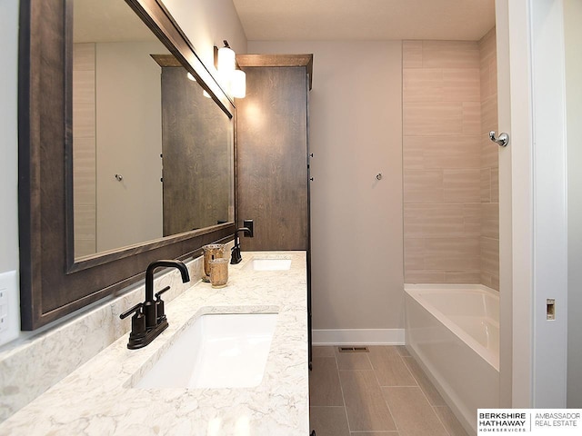 bathroom with vanity and a tub to relax in