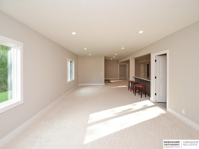 carpeted spare room with a wealth of natural light