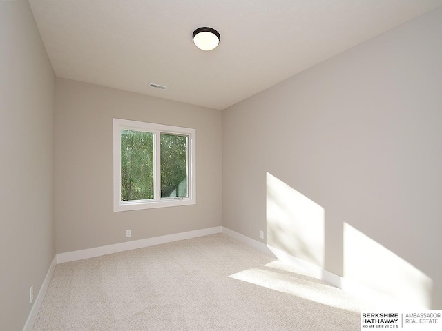 unfurnished room featuring light colored carpet