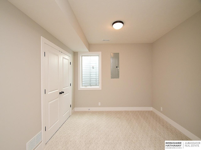 carpeted empty room featuring electric panel