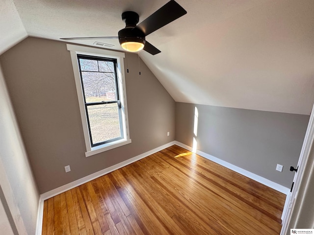 bonus room with hardwood / wood-style floors, ceiling fan, and lofted ceiling