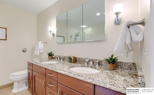 bathroom featuring tile patterned floors, vanity, toilet, and a shower with door