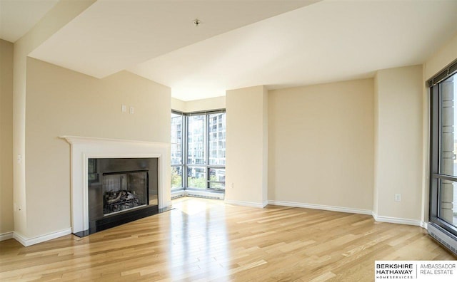 unfurnished living room with light hardwood / wood-style flooring